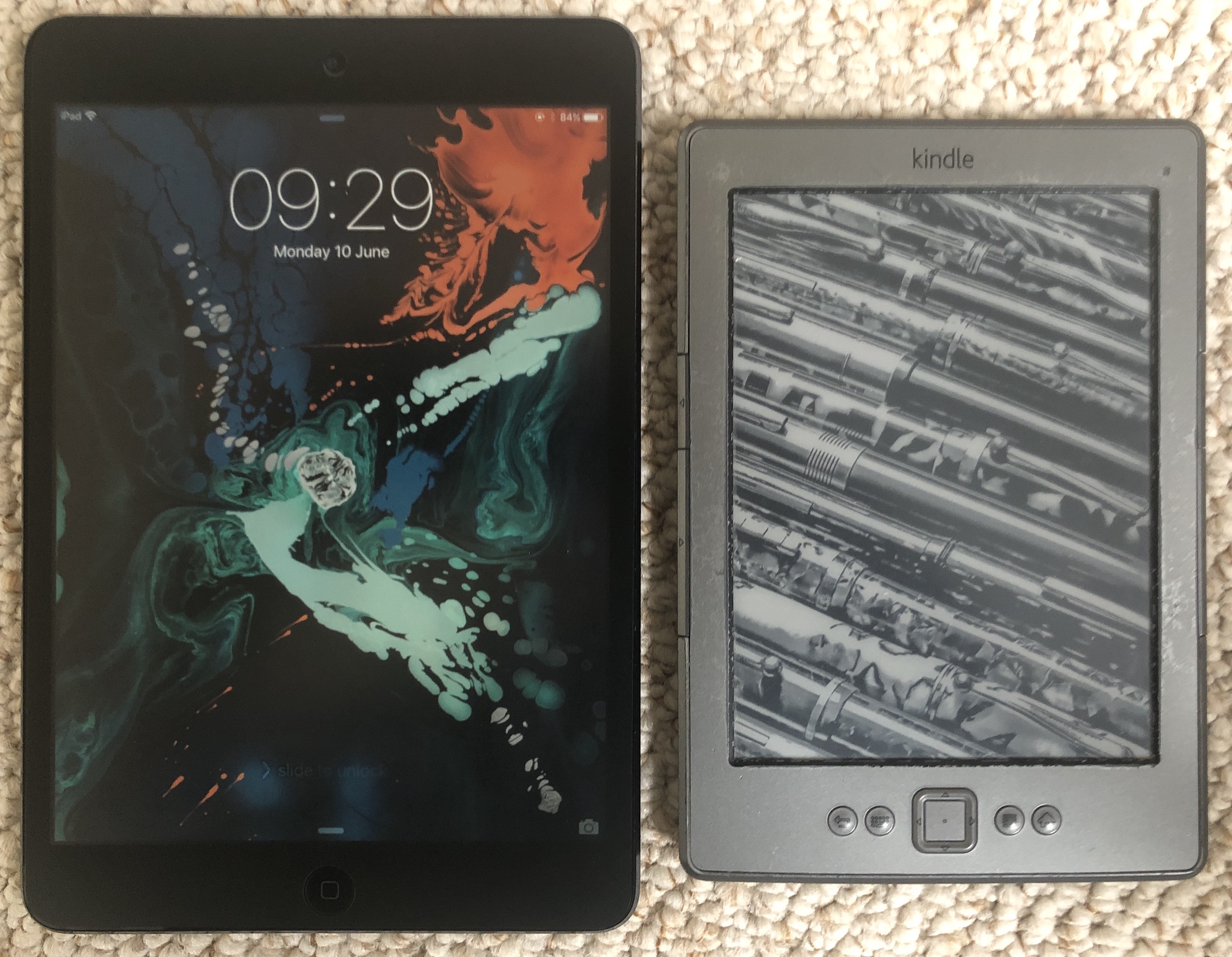 iPad Mini next to a Kindle